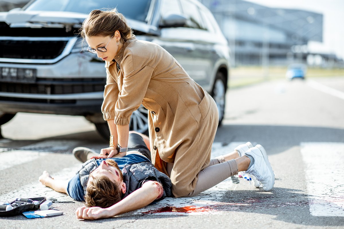 An injured pedestrian on the ground after a collision