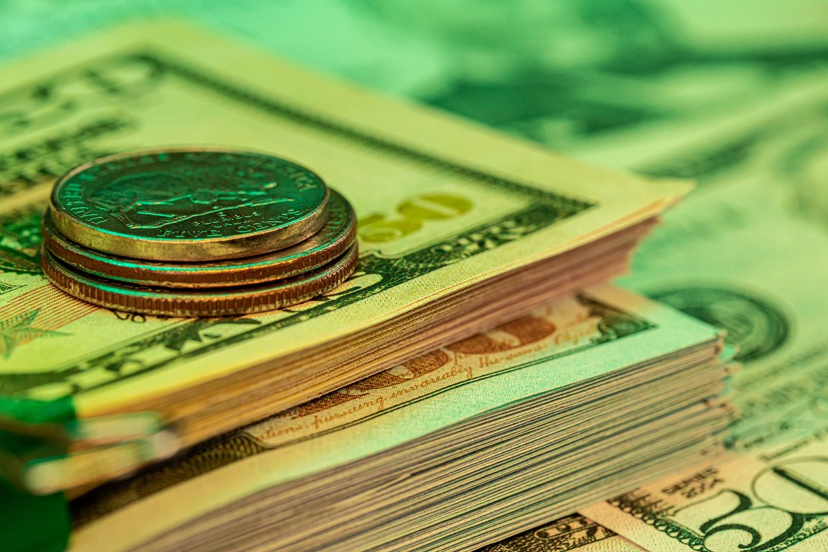 Bundles of dollar bills and some coins on a table